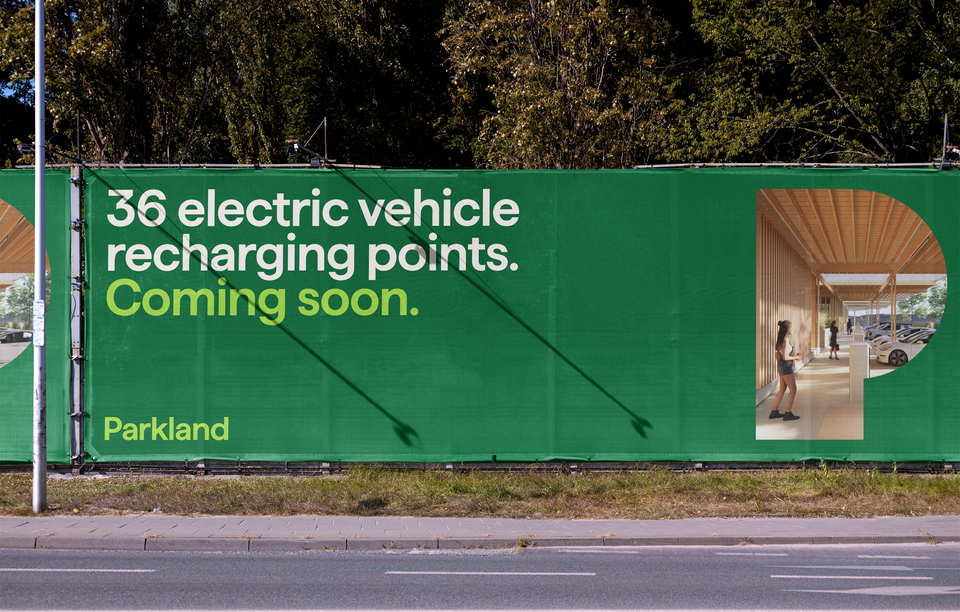 A hoarding with the text 36 electric vehicle charging points, coming soon. A rendering of an electric vehicle charging station is shown within the shape of the Parkland P logo