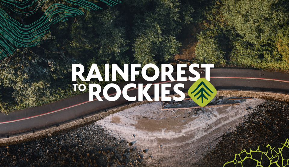 a photo of a bike lane between a forest and the ocean, with a logo that says Rainforest to Rockies overlaid on it