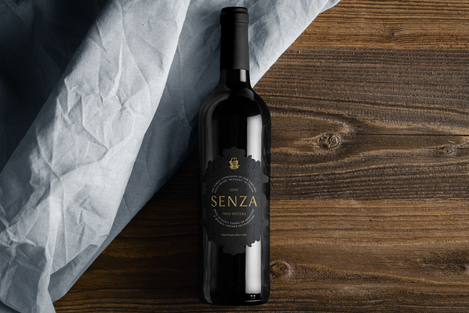 a bottle of wine with a label reading 2016 Two Sisters Senza