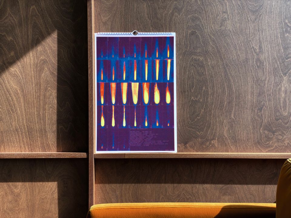 A May 2022 calendar depicting Halley's Comet on a wood paneled wall